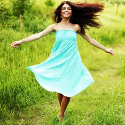image of woman running free in the green field