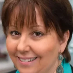 psychic terri-ann from absolute soul secrets smiling at the camera with short brown hair with warm highlights