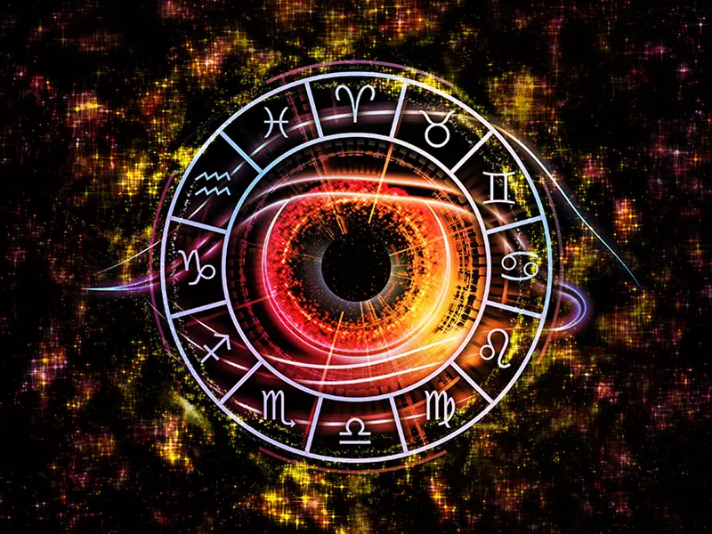 zodiac wheel with an eye in the middle on a dark background with orange and earth tone themes