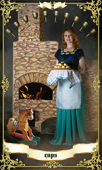 red haired woman wearing long green skirt in front of fireplace with 10 cups above her head