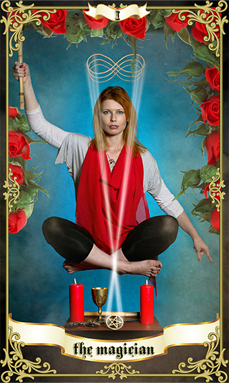 a red haired woman wearing a red cloak levitating over 2 red candles representing the magician tarot card