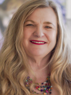 rose smith has long blonde hair wearing bright necklace beads