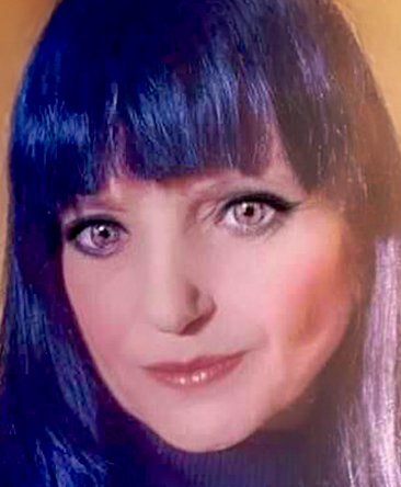 Portrait of psychic Dee Dee, a naturally gifted psychic medium with long dark hair, known for phone readings, Twin Flame guidance, and tarot insight