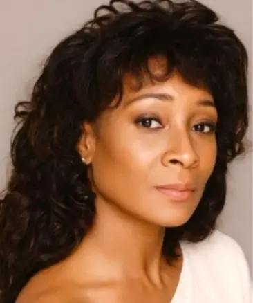 Psychic Carolyn with dark hair and cream top id 2017