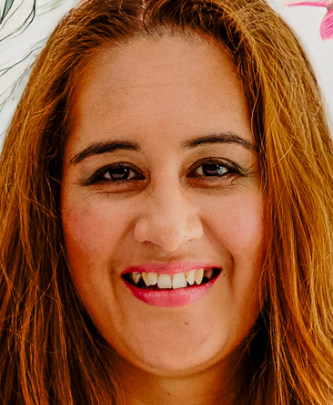 Portrait of Lara, a warm and approachable psychic reader with long auburn hair and a bright smile, offering empowering psychic readings that blend intuitive insight with practical guidance.
