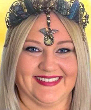 Close-up of Psychic Lee, a smiling Australian psychic medium wearing a decorative headpiece with crystals and a central pendant, symbolising her connection with spiritual guidance and psychic readings.