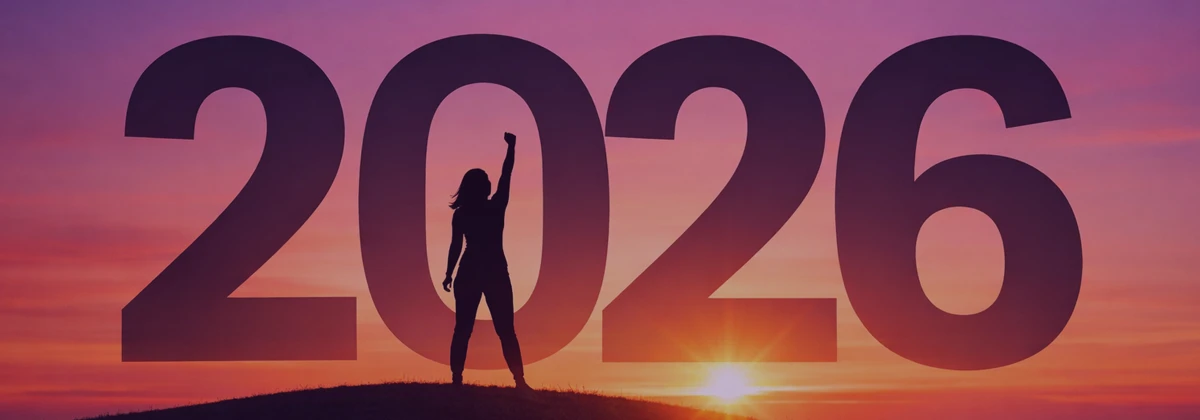 Silhouette of a woman standing on a hill with one arm raised in triumph, set against a warm sunrise sky with the large year “2026” in bold lettering behind her.
